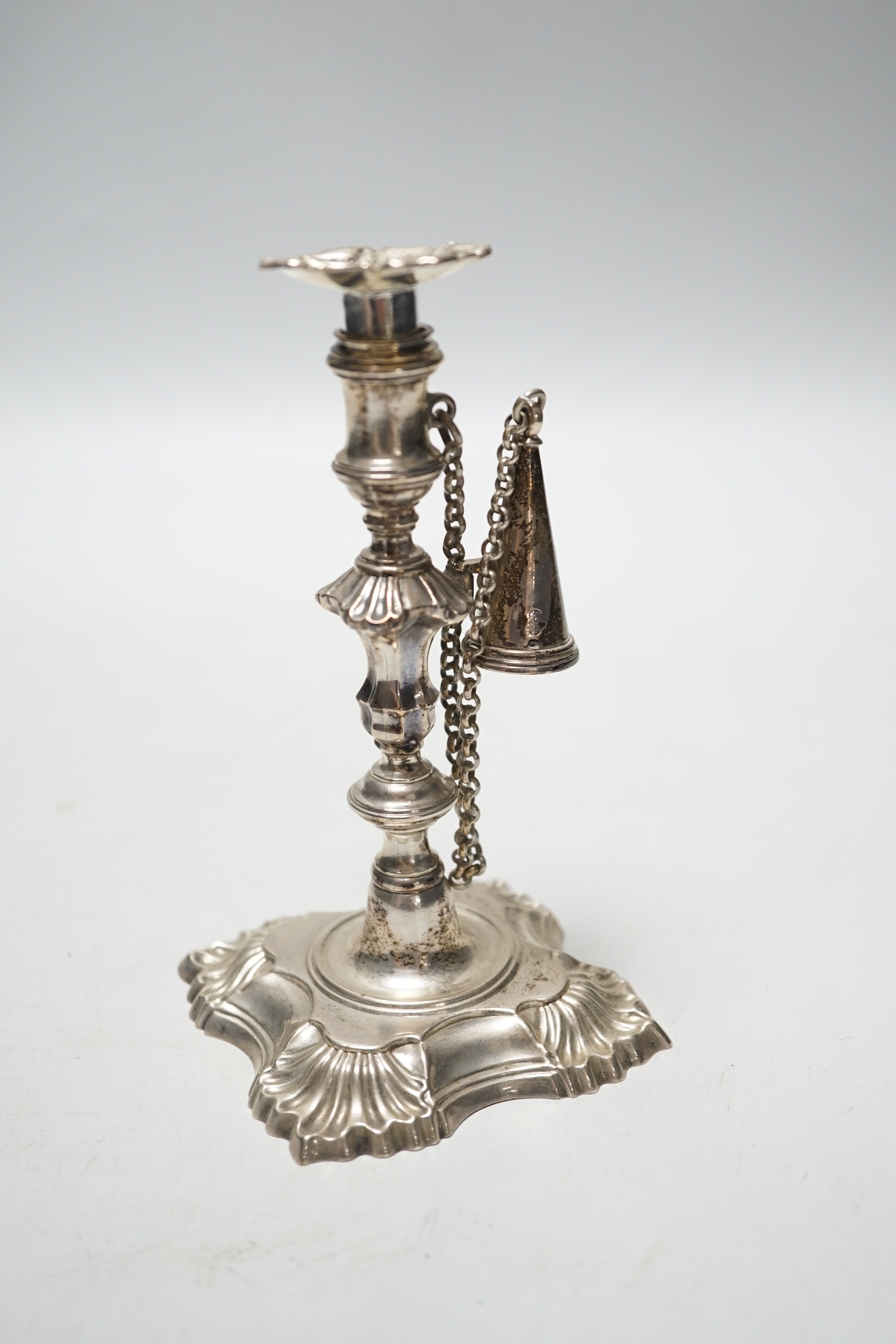 A George II cast silver taper stick, William Gould, London, 1751, with later George IV extinguisher and unmarked sconce, 13.3cm, 6.7oz.